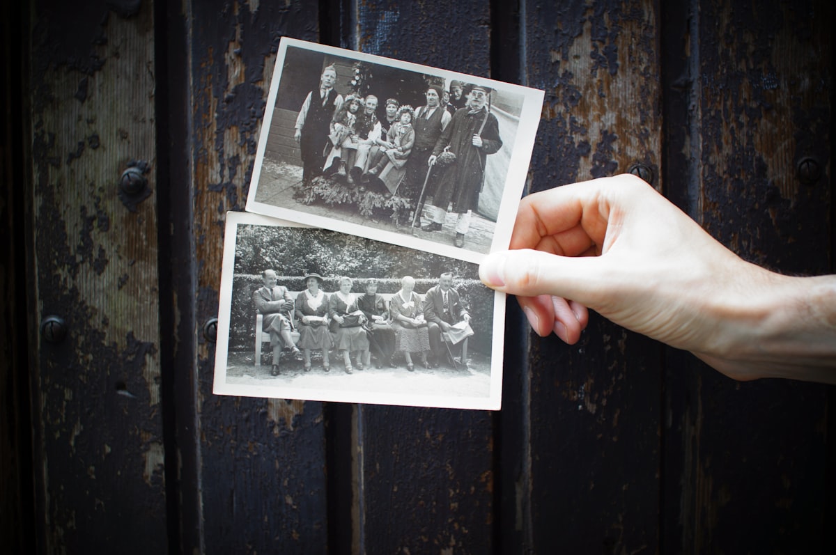 Hands holding vintage family photographs